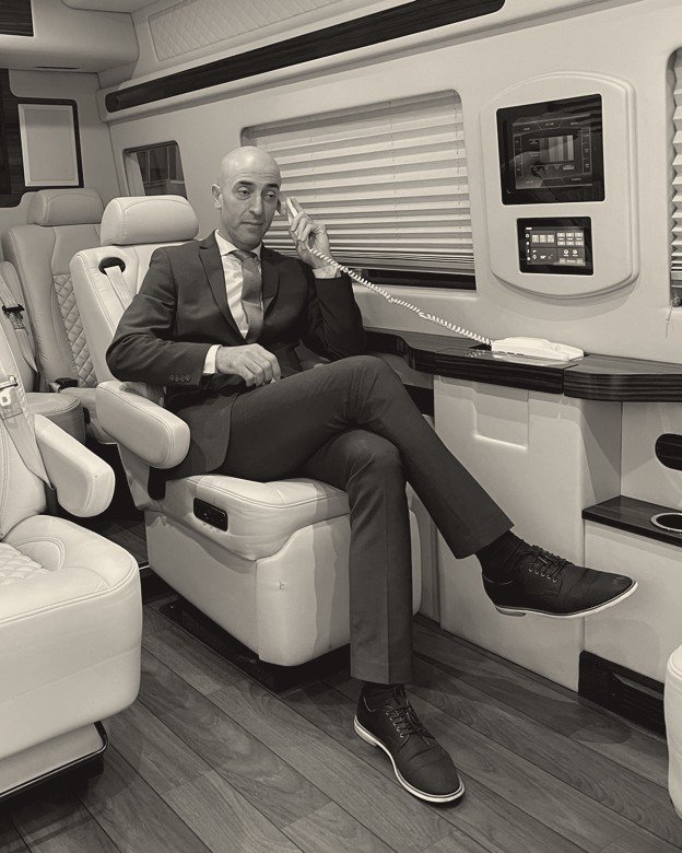Hakim Benbader, founder of Star Ride, taking a call in a Jet-Class Sprinter
